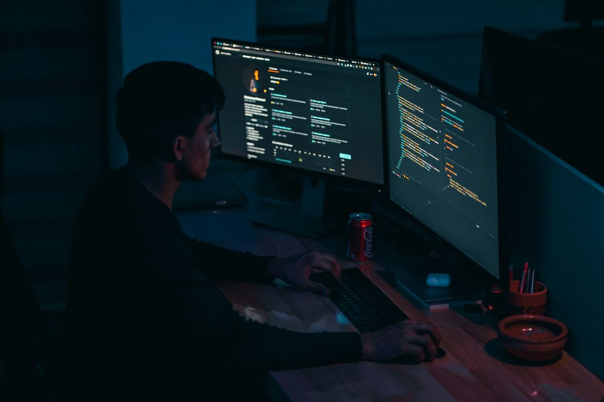 A developer deep in focused work across two screens