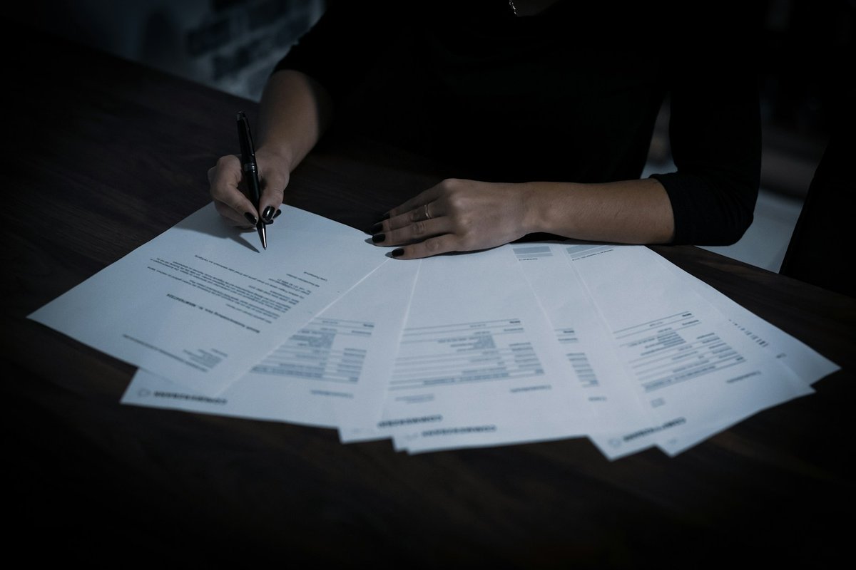 Working through a spread of case papers at a desk